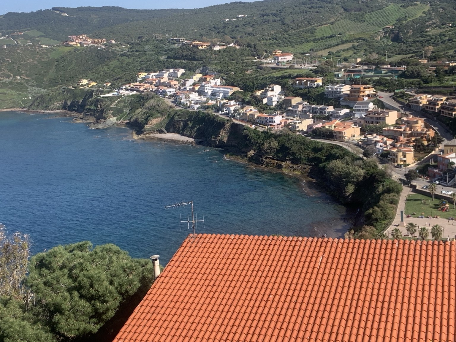 Sardinian village rooftops overlooking the blue sea